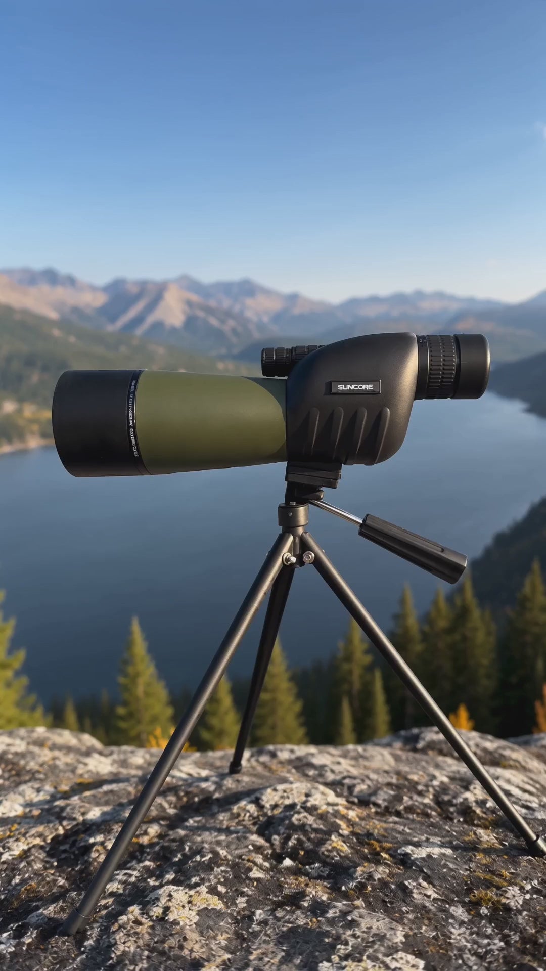 High-powered spotting scope with tripod overlooking a mountain lake, ideal for birdwatching, wildlife viewing, and long-distance observation.